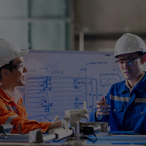 Engineering students collaborating on technical design and machinery planning