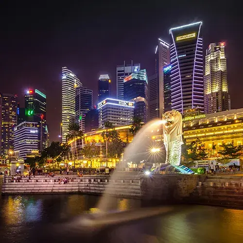 Study in Singapore with a view of the Merlion and Marina Bay skyline at night